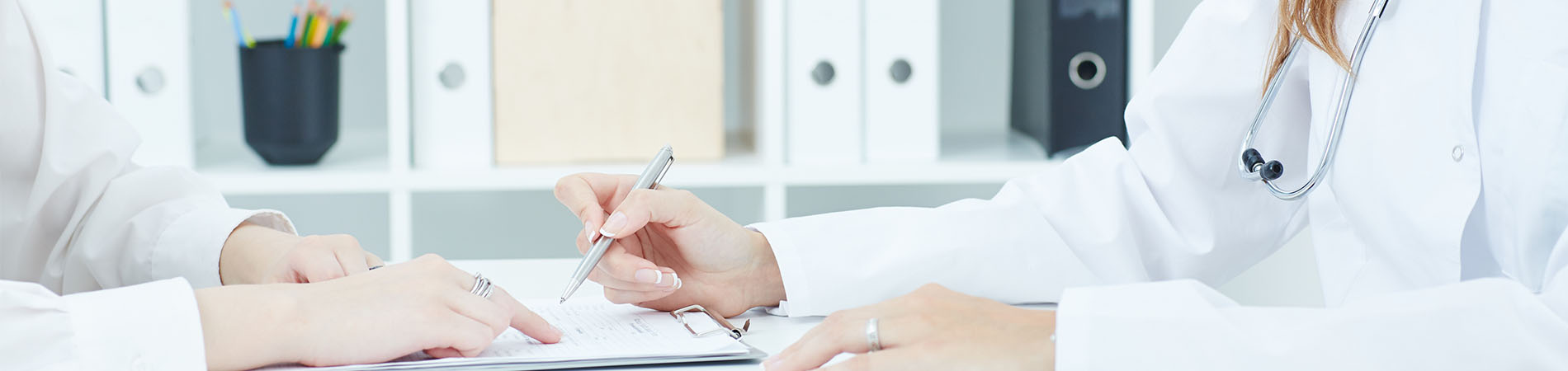 A doctor signing something at a medical practice