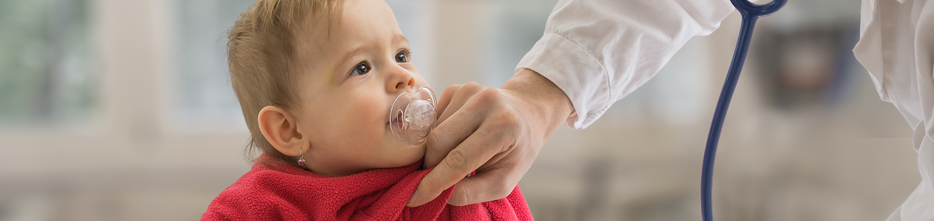 A physician examining a small child to represent CHIP care