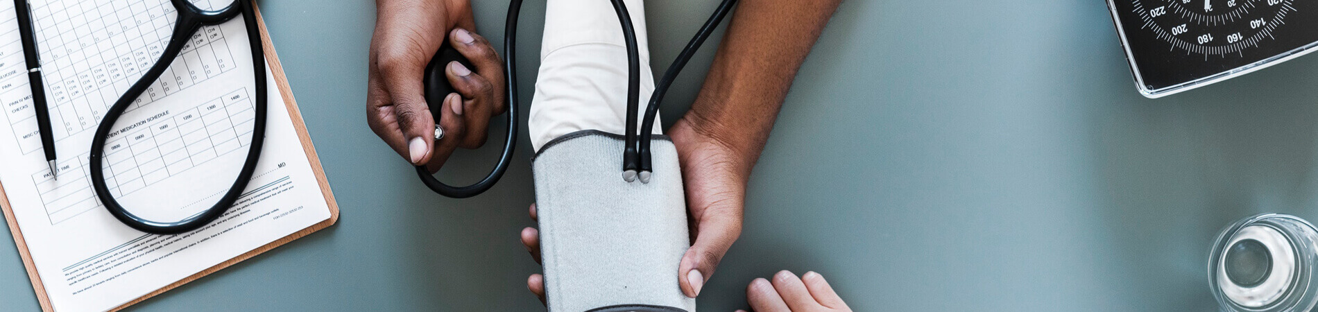 Patient experience represented by a doctor being hands on with a patient through a vitals check