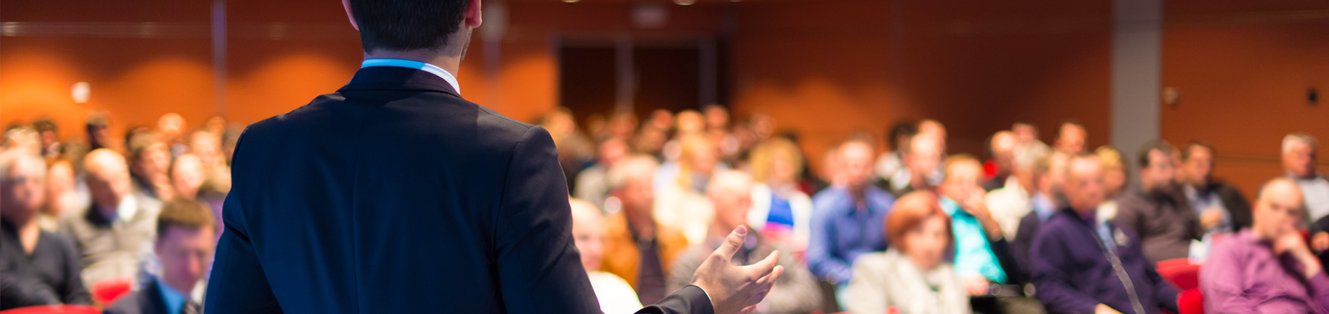 A professional presenting in front of a crowd of people at a vendor conference