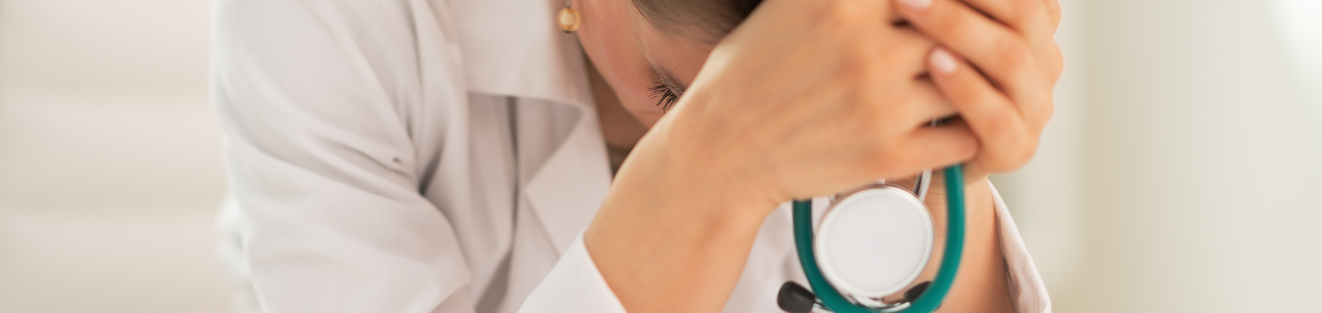 A female provider showing signs of physician burnout