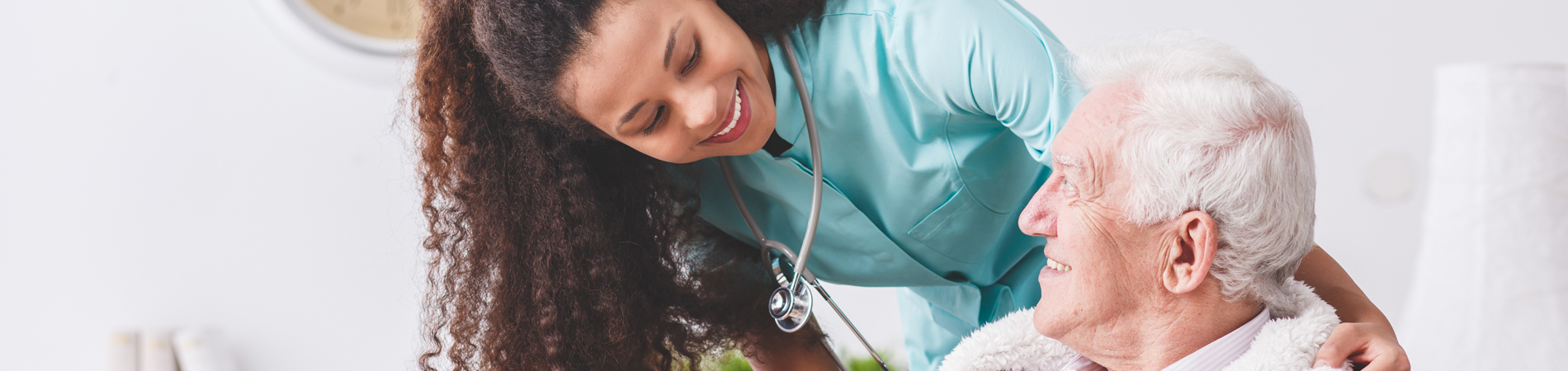 Nurse is improving the patient experience by interacting with an elderly patient