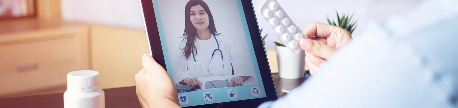 a telehealth visit shown through a patient showing a provider medicine