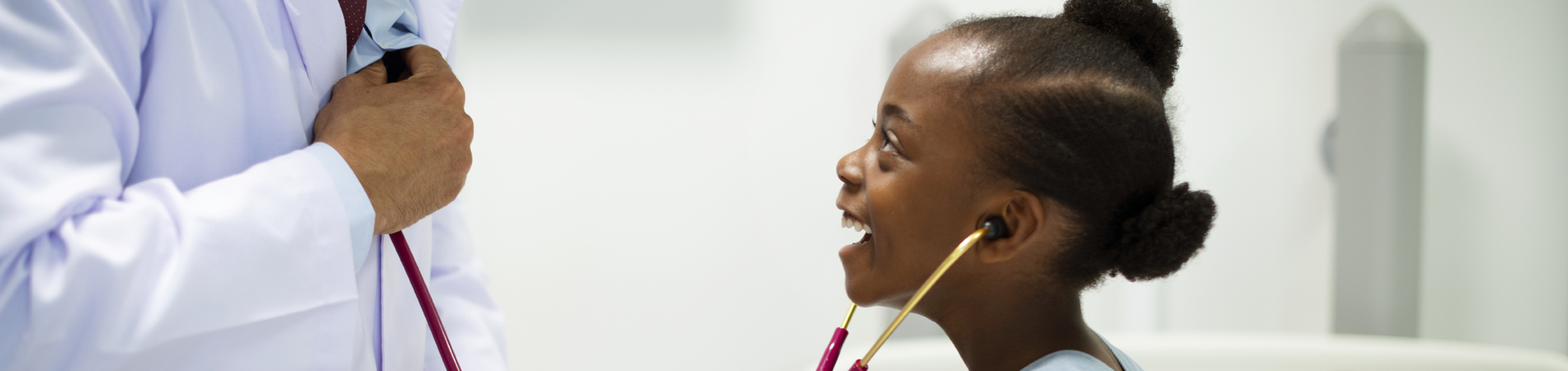 a young girl gets to hear the doctors heartbeat with a stethoscope