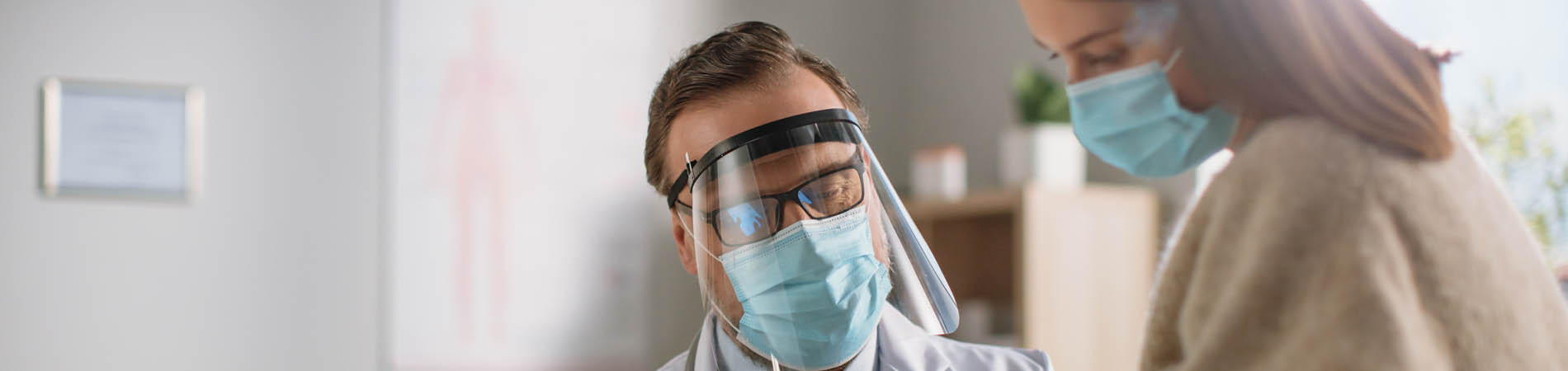 A male doctor runs through prescription or treatment information with a female patients