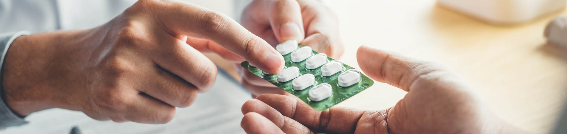 A provider explaining a medication to a patient to boost medication adherence