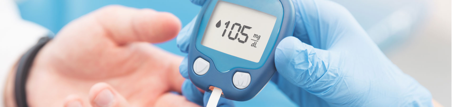 Doctor checking blood sugar level with glucometer